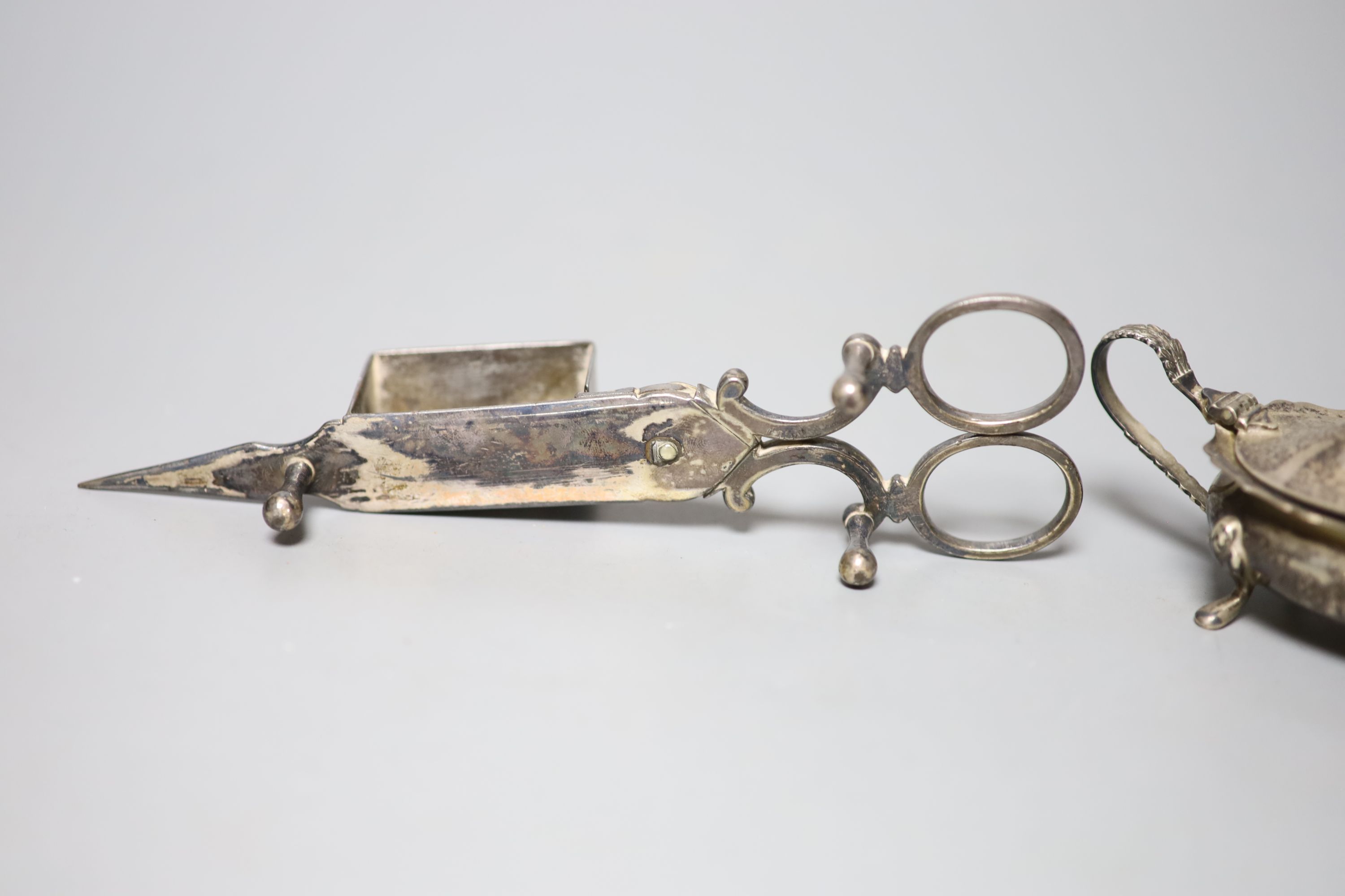 A silver three piece condiment set, a Dutch white metal pill box and a pair of plated candle snuffers.